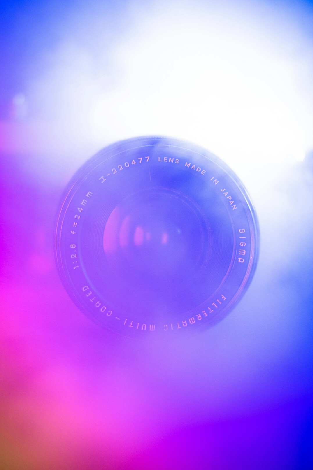 Camera lens close-up with colorful reflections on a studio camera